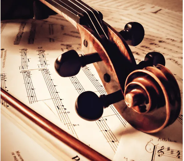 Volute de violon posée sur une partition